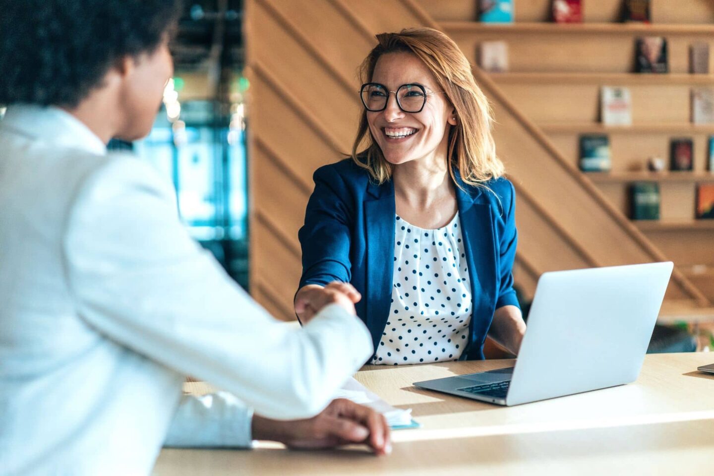 Woman with large mouth smiling at man across table