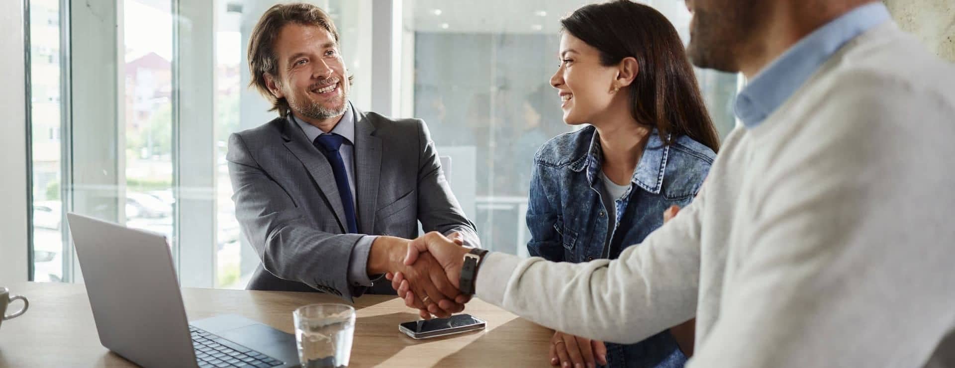 Man shaking hands with couple