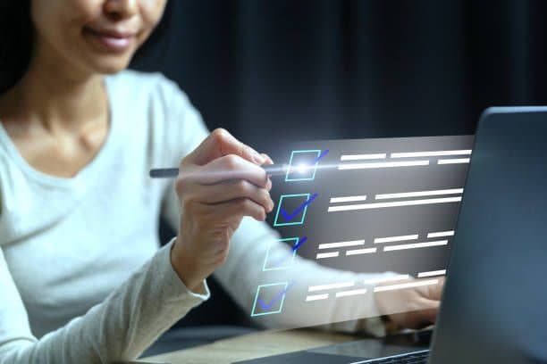 Woman using a digital pencil on a screen floating in front of her